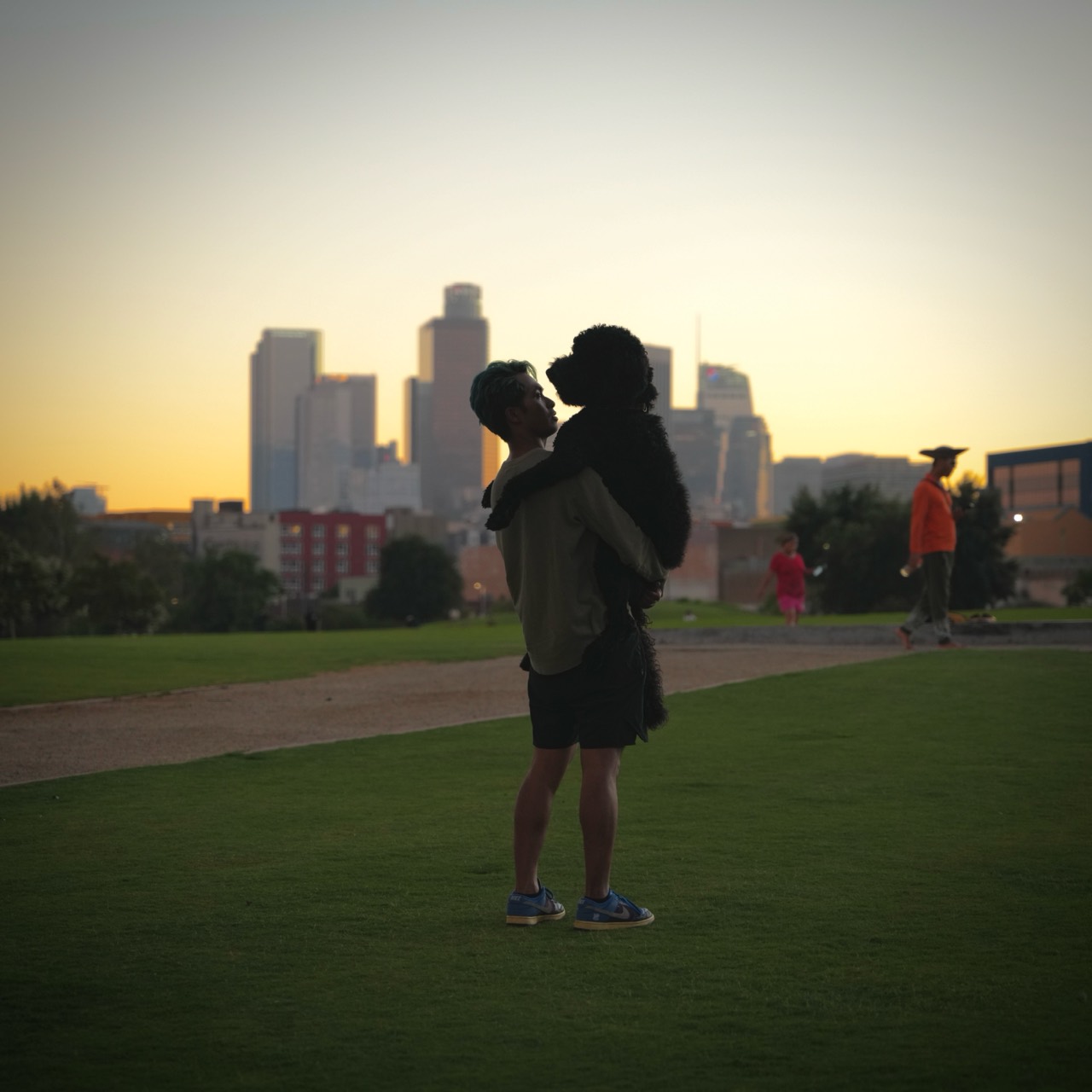 Alvin Octoman holding Kobeyoshi with the Los Angeles skyline at dusk