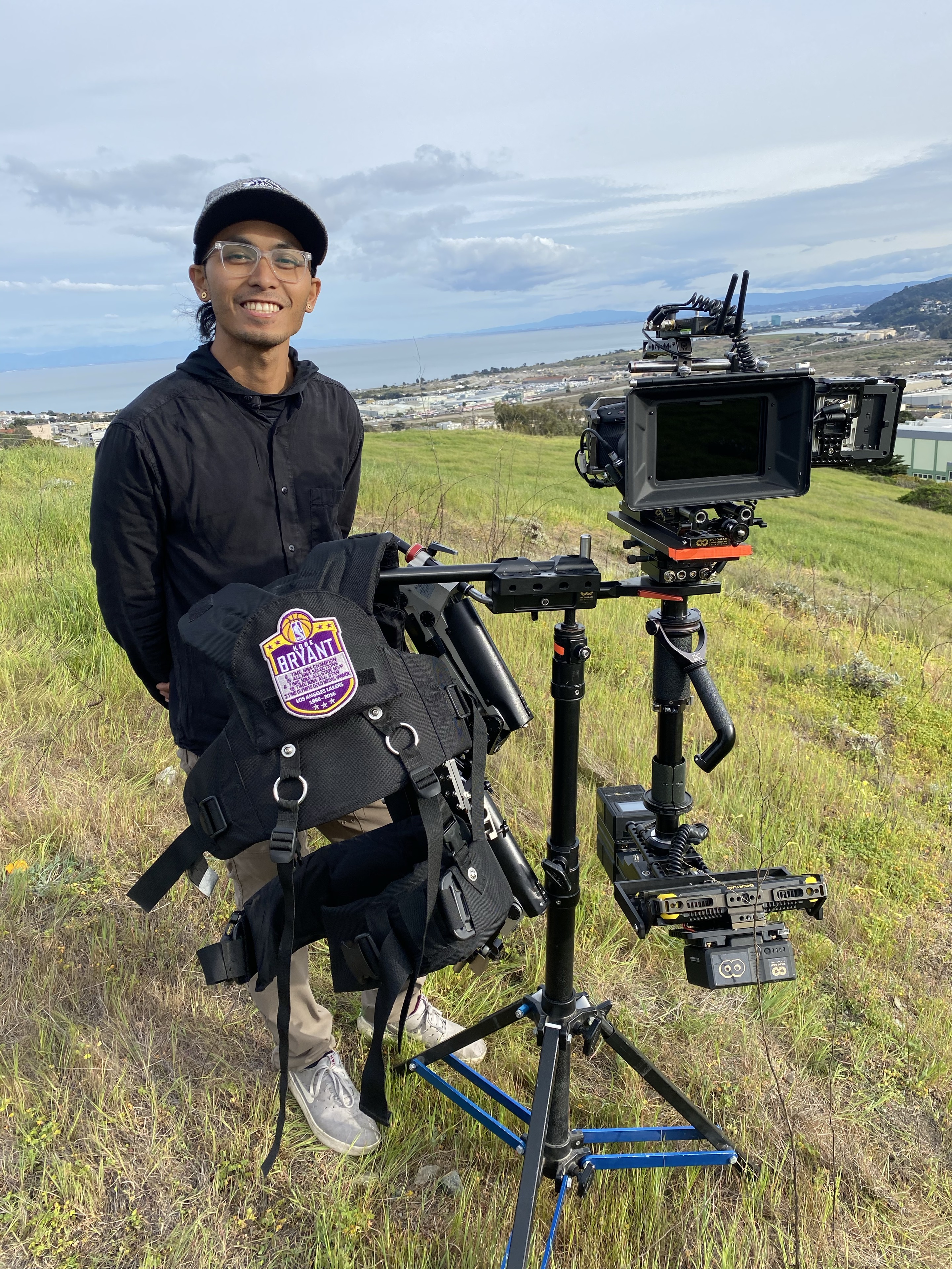 Alvin Octoman smiling beside his Steadicam rig on location